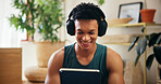 Home, man and tablet with headphones for fitness, virtual exercise and application for audio track. House, male person and break with technology for social media, workout tips and music with smile