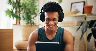 Buy stock photo Home, man and tablet with headphones for fitness, virtual exercise and application for audio track. House, male person and break with technology for social media, workout tips and music with smile