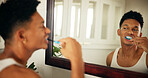 Home, man and dental with toothbrush in mirror, oral care and mouth treatment in morning routine. Reflection, male person and wellness with teeth whitening for gums, hygiene and grooming in bathroom