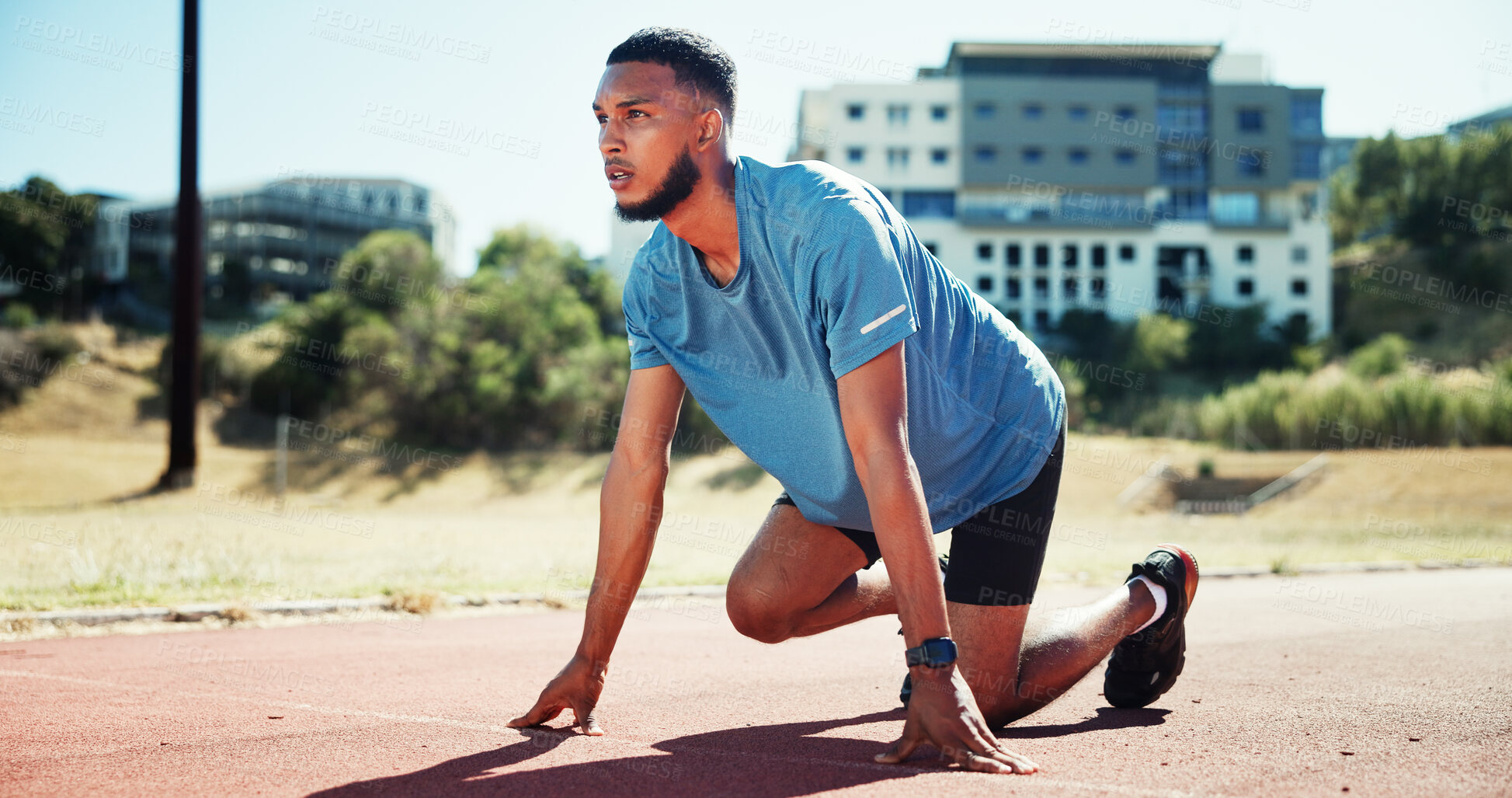 Buy stock photo Ready, sports and athlete or man on running track for fitness, training and cardio performance. Health, marathon and runner with person and outdoor stadium for competition, start and workout