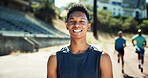 Portrait, active and black man with smile at stadium for exercise, sports training and practice on track field. Male runner, happy and pride for fitness, workout and endurance of marathon competition