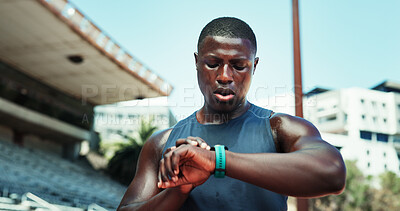 Buy stock photo Athlete, black man and check watch at stadium for running speed, fitness stats and workout performance. Runner, sweating and wristwatch outdoor for tracking heart rate, marathon progress and lap time