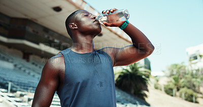 Buy stock photo Stadium, black man and fitness with drinking water for wellness, hydration and nutrition on workout break. Outdoor, male person and athlete with bottle for h2o liquid, detox and beverage for exercise