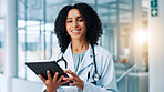 Doctor, woman and smile with tablet in portrait, hallway and report for healthcare services at clinic. Person, touchscreen and happy with app, medical research or schedule at hospital in Costa Rica