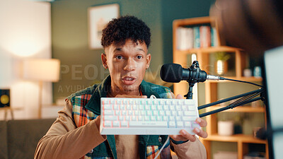 Buy stock photo Content creator, keyboard and man with microphone for review, podcast or social media promotion. Filming, product and influencer show tech for live streaming, opinion or gaming gear with RGB at home