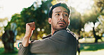 Fitness, exercise and man with stretching at park to start training, cardio performance and getting ready. Runner, athlete and arm warm up in nature for workout, muscle tension relief and wellness