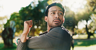 Buy stock photo Fitness, exercise and man with stretching at park to start training, cardio performance and getting ready. Runner, athlete and arm warm up in nature for workout, muscle tension relief and wellness