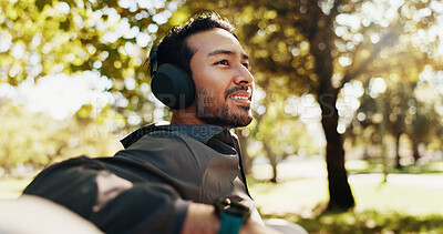 Buy stock photo Thinking, man and headphones for fitness in city by listening to music, streaming audio and break. Male person, thoughts and relax with exercise podcast, workout recovery and ideas of sports training
