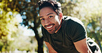 Tired, running and portrait of man in nature for cardio workout, exhausted and training break. Smile, health and fitness rest with person outdoor for fatigue, sports athlete and marathon practice