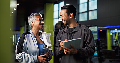 Buy stock photo Man, woman and talking with tablet at gym for advice, sign up and smile for exercise tips. Mature person, personal trainer and touchscreen with training app, workout and discussion at fitness center