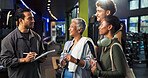 Man, group and sign up with tablet at gym for class, registration and smile with exercise tips. People, personal trainer and touchscreen for welcome to club, app and discussion at fitness center