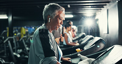 Buy stock photo Fitness, earphones and music with woman on treadmill for workout playlist, training club and runner. Streaming, exercise and health podcast with mature person on running machine for radio and gym