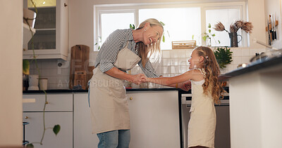 Buy stock photo Dancing, mom and smile for child in kitchen, together and teaching moves to daughter in home or fun. Laughing, woman and bonding with girl in house, happy and energy with kid in apartment or family