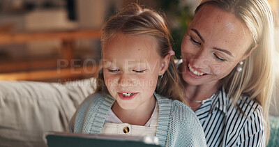 Buy stock photo Home, mother and girl with tablet, smile and bonding together with online entertainment. Happy family, apartment and parent on sofa, mama and daughter with tech, internet and help with education app