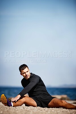 Buy stock photo Man, stretching and sports by ocean for exercise with fitness motivation, sand and blue sky. Male person, training and nature at beach with workout for wellness, strong body and health activity