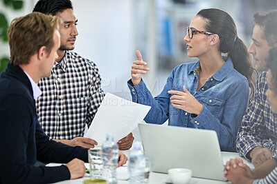 Buy stock photo Confident businesswoman explaining an idea to her colleagues at a meeting