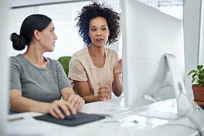 Buy stock photo Shot of two creative businesspeople working together on a computer in the office