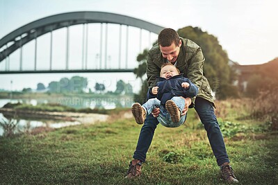 Buy stock photo Family, playing and father with baby in park for bonding, relax and laugh together outdoors. Nature, blue sky and happy dad carry young boy for child development, love or fun on weekend or holiday