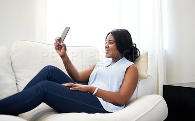Buy stock photo African woman, cellphone and video call in house on couch with cheerful, smile and excited at home. Female person, lounge and sofa with technology for connection, communication and photography