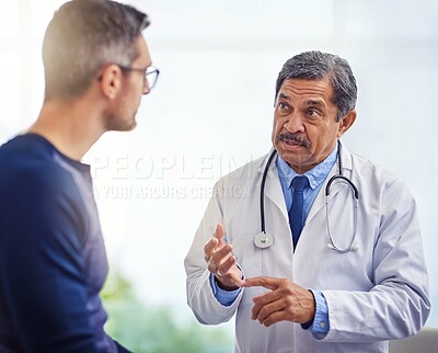 Buy stock photo Man, doctor and consulting with patient for advice, medical assurance or dosage at hospital. Mature, male person or healthcare professional talking or explaining instructions to client at clinic