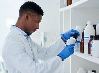 Buy stock photo Scientist, chemical and black man with bottle in lab for medical research, information and healthcare. Chemistry, medicine and person in science with thinking for production, innovation or experiment