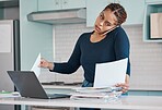 Black business woman working from home in freelance, multitasking paperwork with laptop and mobile audio phone call. Internet technology in kitchen, consulting invoice documents in covid pandemic