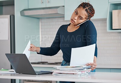 Buy stock photo Black business woman working from home in freelance, multitasking paperwork with laptop and mobile audio phone call. Internet technology in kitchen, consulting invoice documents in covid pandemic