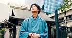 Man, thinking and urban city with traditional fashion, outfit and yukata for heritage. Travel, Japanese guy and vacation for culture, journey and sightseeing with casual dress kimono and downtown