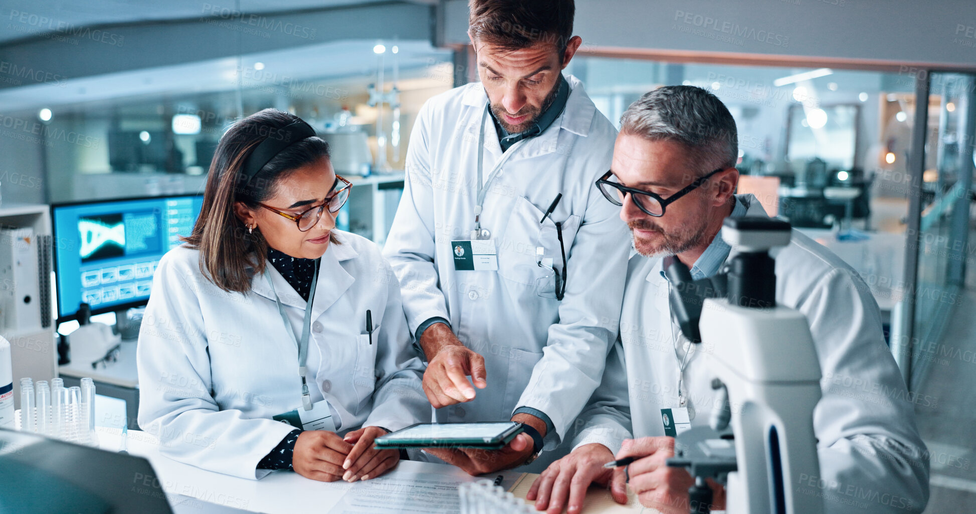 Buy stock photo Medical, science and tablet with people in laboratory together for breakthrough or development. Feedback, microscope and review with research team in clinical trial for conversation or discussion