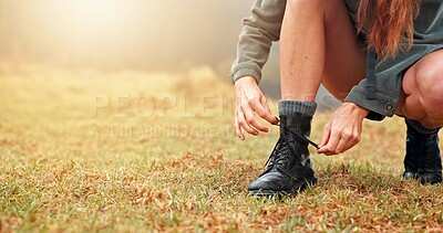 Buy stock photo Boots, hiking and woman tying laces outdoor for activity, exploring or adventure on holiday. Fitness, hands and closeup of female person getting ready with shoes for trekking in nature for exercise.