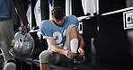 Tie, laces or football player in locker room for sports preparation, match and waiting on game. Athlete, start or getting ready at half time of competition, fitness challenge and tournament event