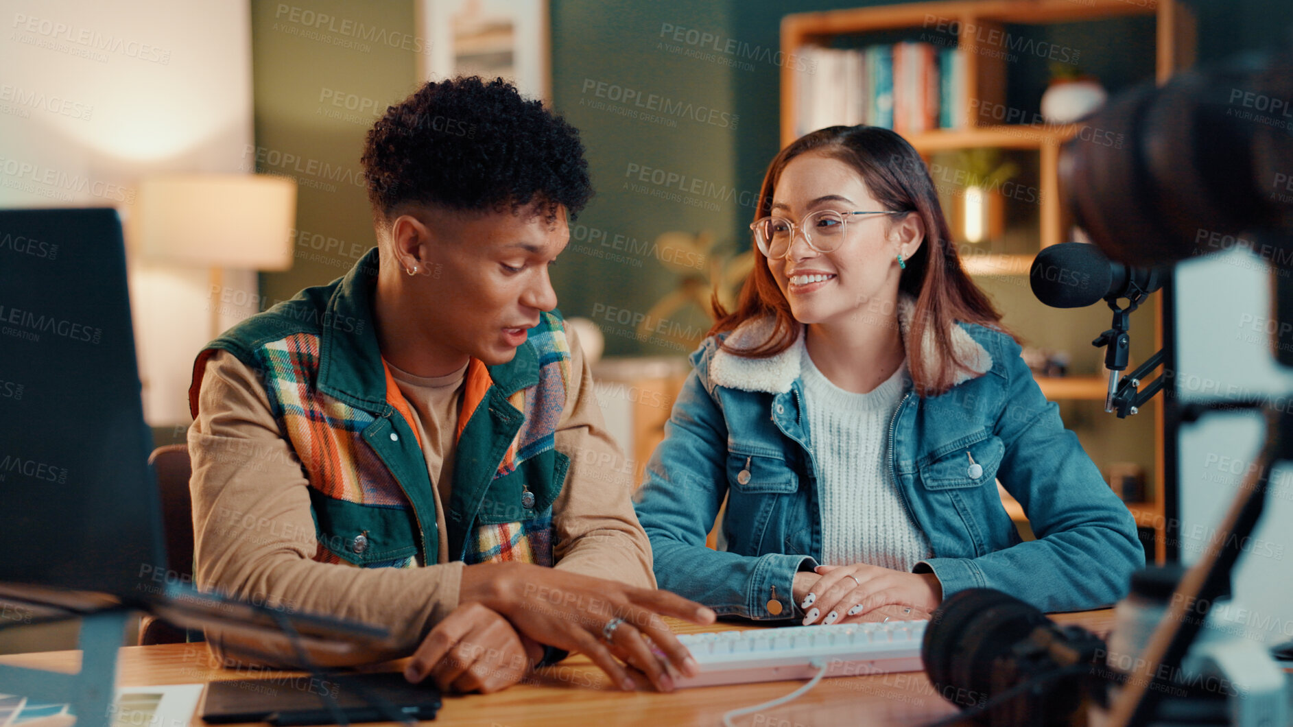 Buy stock photo Man, woman and live stream in home studio with mic, camera and planning for online talk show. Influencer couple, recording equipment and discussion for web channel, podcast or social media at house