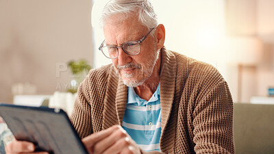 Buy stock photo Senior man, tablet and typing on sofa in home with search for ebook title, story or newsletter in lounge. Elderly person, digital touchscreen and application for movies, film or video in retirement