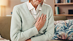 Senior woman, hands and sofa with chest pain for medical emergency or cardiac arrest at home. Closeup, elderly or female person with discomfort or lung disease for heartburn or heart attack at house