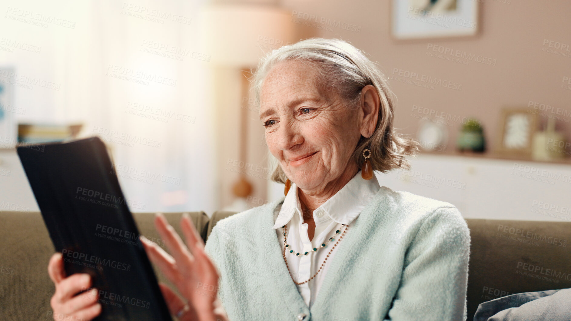 Buy stock photo Home, tablet and senior woman on sofa, smile and retirement with social media, internet and app. Pensioner, apartment and elderly person on couch, tech and email with information, chatting and typing