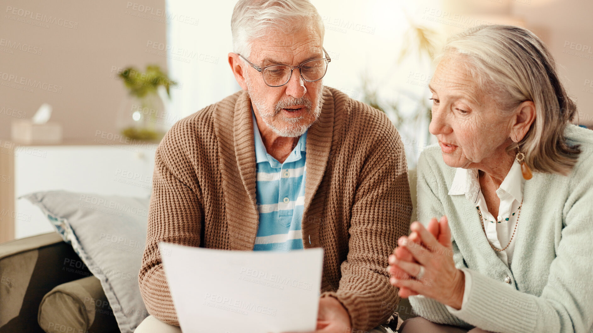 Buy stock photo Elderly couple, documents or home with finance on sofa for budget or financial planning together. Senior, man and woman with paperwork, bills or expenses for mortgage invoice, rent or retirement fund