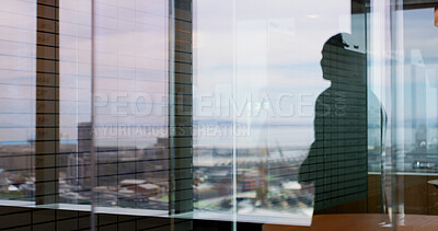 Buy stock photo Silhouette, business and person at window in office for architecture, career ambition and buildings. Architect, vision and property development, urban infrastructure and city view for town expansion