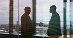 Businessmen, shadow and window with handshake in reflection for deal or agreement on balcony. Silhouette, employees or shaking hands with mirror vision for negotiation, meeting or partnership in city