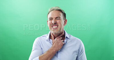 Buy stock photo Sore throat, sickness and virus with man in studio for allergies, influenza symptoms and illness. Fatigue, sinus congestion and healthcare with person on green background for infection and cold