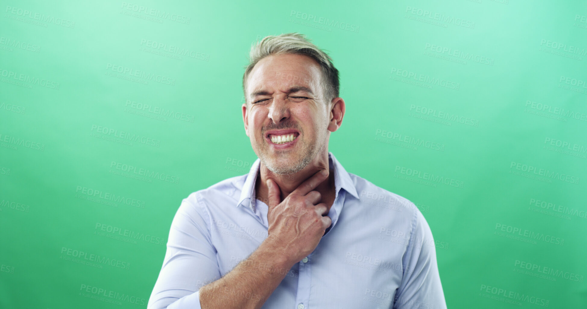 Buy stock photo Sore throat, sickness and virus with man in studio for allergies, influenza symptoms and illness. Fatigue, sinus congestion and healthcare with person on green background for infection and cold