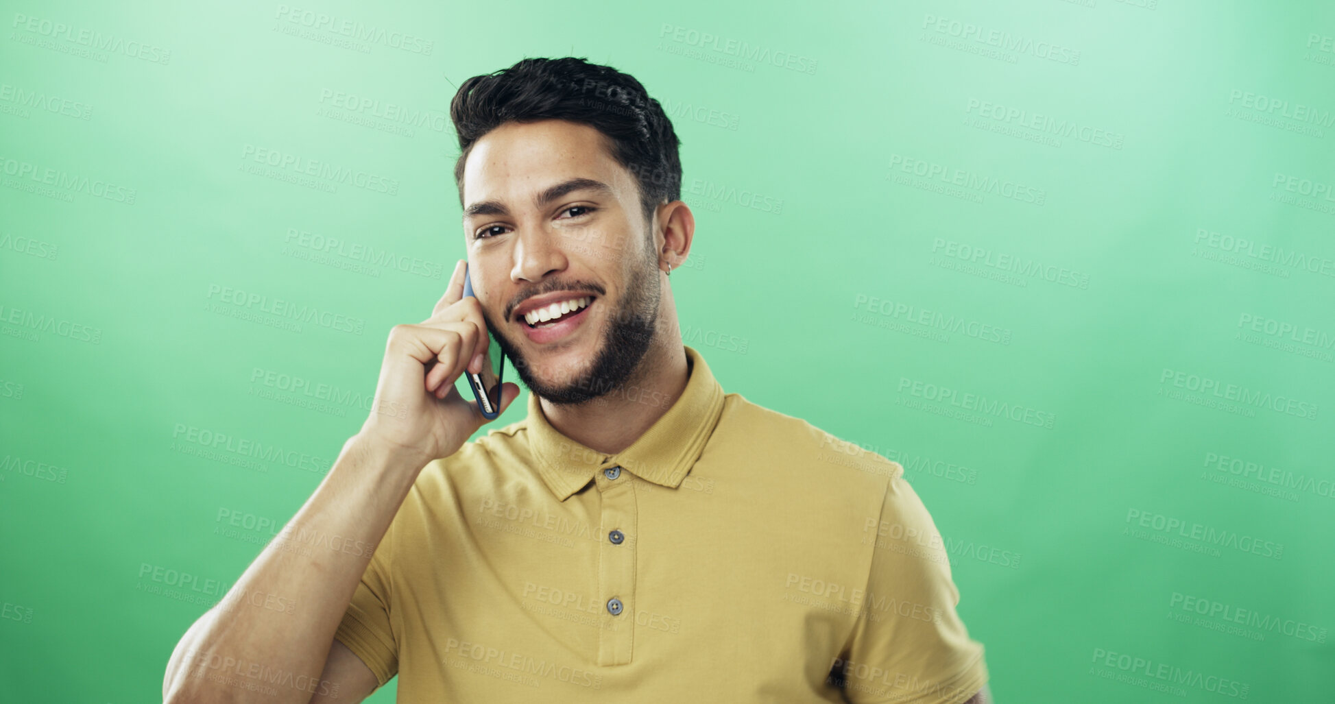 Buy stock photo Man, phone call and happy in studio portrait with talk, listen and connection by green background. Person, smartphone and conversation with mobile network, smile or chat with mockup space in Colombia