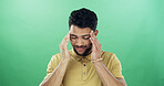 Headache, stress and man in studio with burnout, fatigue or exhaustion for medical sickness. Tired, illness and male person with migraine for flu, cold or allergy symptom by green background.