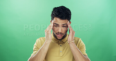 Buy stock photo Headache, tired and man in studio with burnout, fatigue or exhaustion for medical sickness. Stress, illness and male person with migraine for flu, cold or allergy symptom by green background.