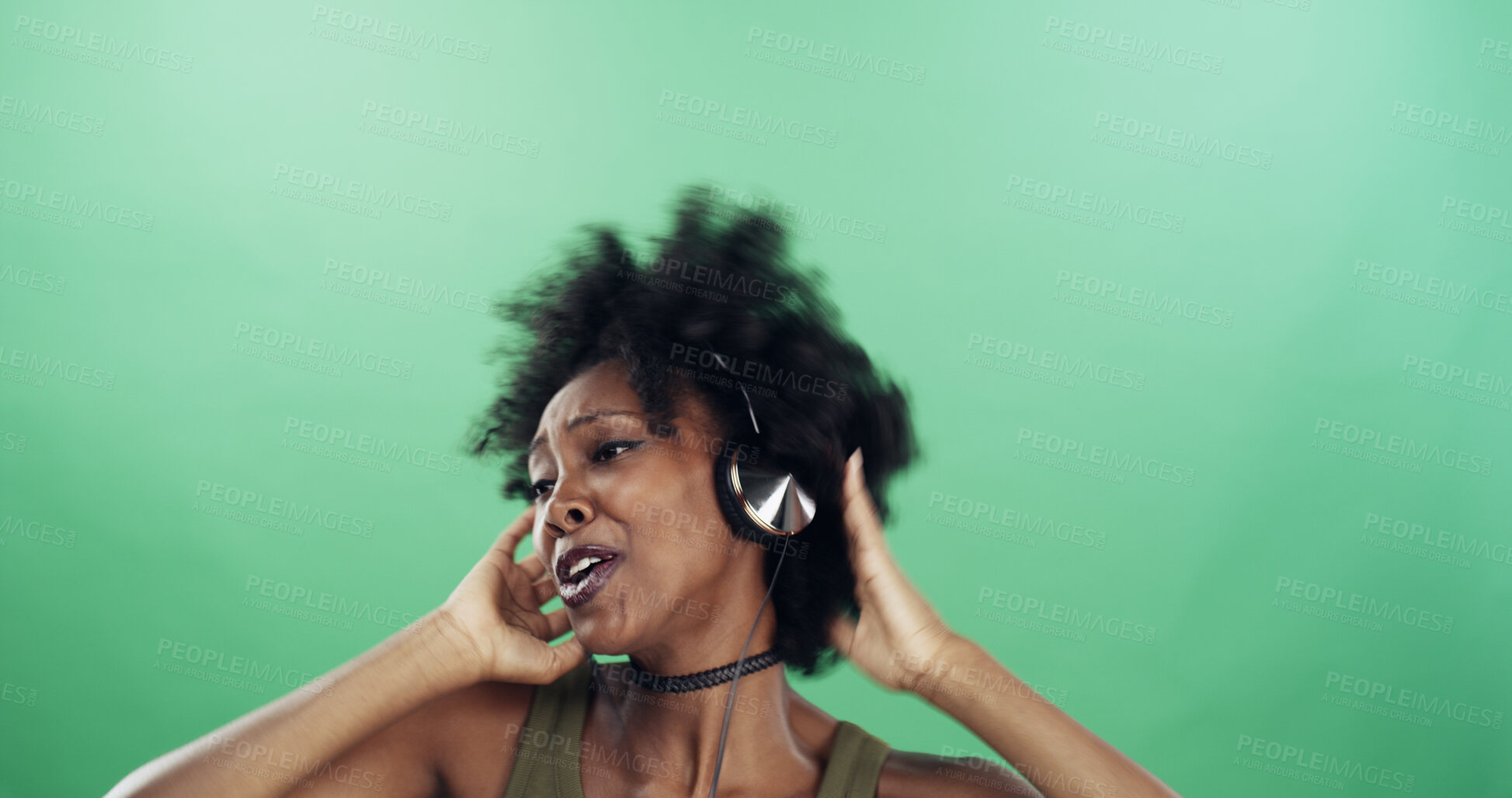 Buy stock photo Dance, headphones and singing with black woman in studio for energy, excitement or radio streaming. Music, rhythm and space with happy dancer person on green background for audio subscription