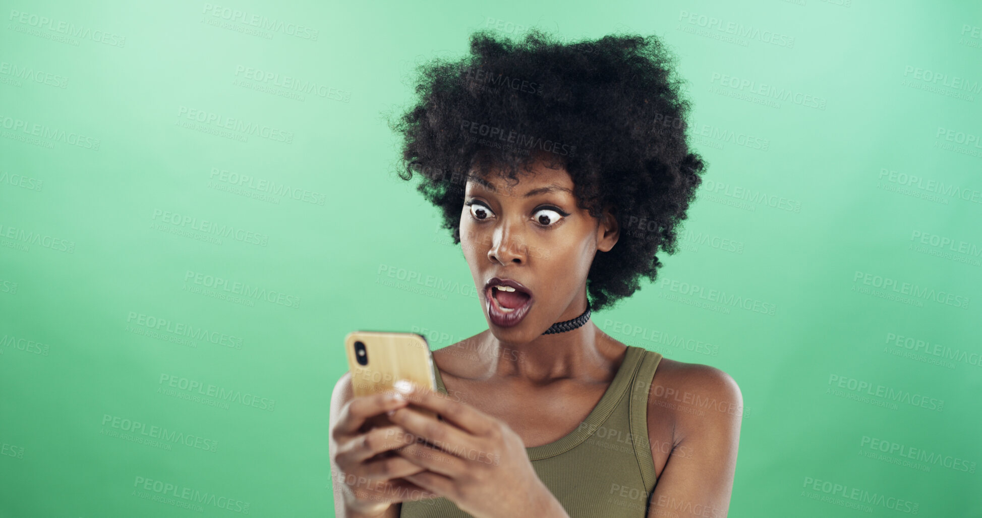 Buy stock photo Phone, shock and text message with black woman in studio for communication of bad news or update. App, serious and social media with reaction of angry person on green background for notification
