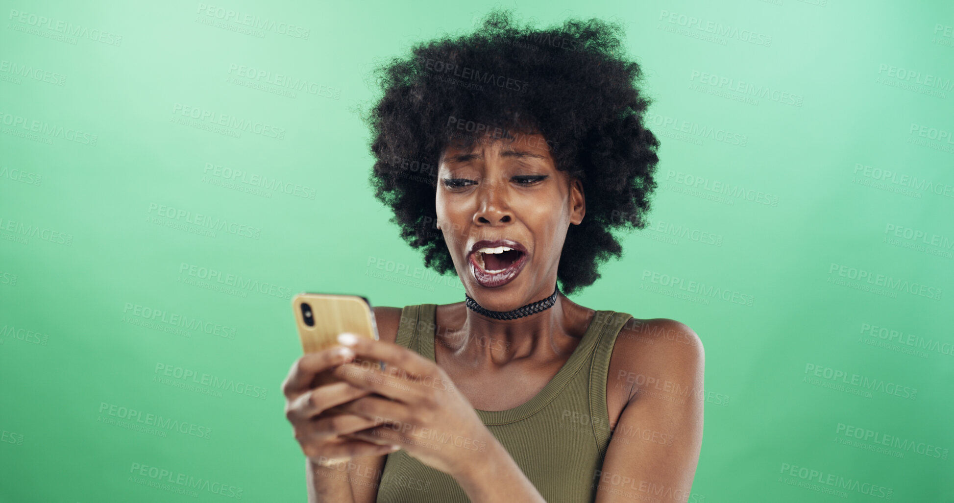 Buy stock photo Crying, phone and shock with black woman in studio for communication of bad news or update. App, surprise and tears with sad or unhappy African person on green background for mobile notification