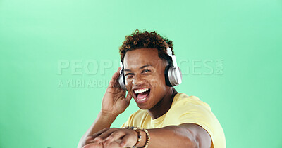Buy stock photo Portrait, dancing and excited black man in headphones with music, mockup space and smile. Green background, song or happy model in studio to celebrate with rhythm, positive energy or streaming sound