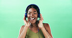 Music, radio and headphones with black woman in studio for streaming, audio playlist and song. Performance, sound and dancing with female person on green background for entertainment and space
