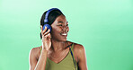 Listen, dancer and headphones with black woman in studio for streaming, audio playlist and music. Performance, sound and radio with female person on green background for entertainment and space