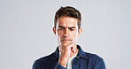 Doubt, man and thinking of solution in studio for problem solving, wondering and fake news. Mockup space, person and contemplating with question, confused or uncertainty with frown on gray background
